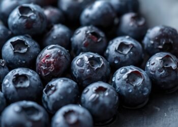 Fresh blueberries in a bowl showing nutrition and calorie content