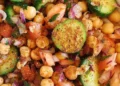 Healthy chana chaat with chickpeas, cucumber, tomatoes, red onion and fresh coriander